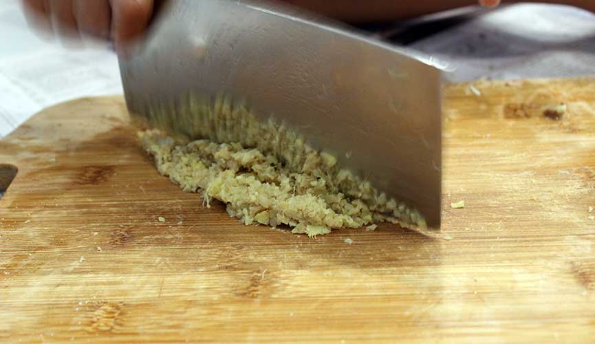 Chopping ginger for chicken rice