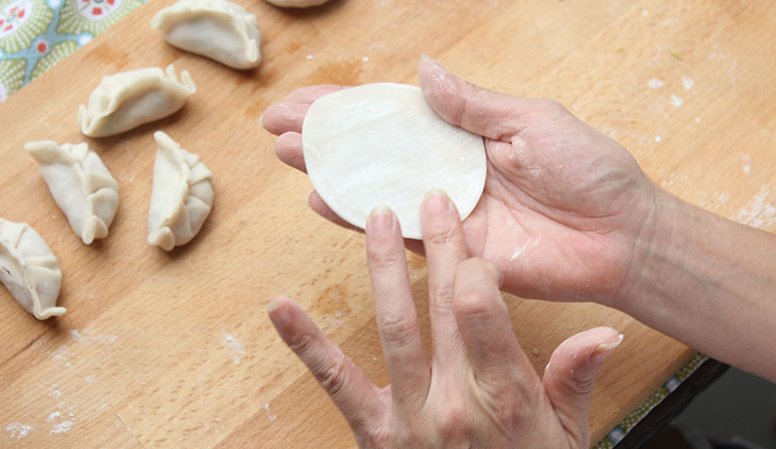 Take one wrapper and wet the edges with plain water.