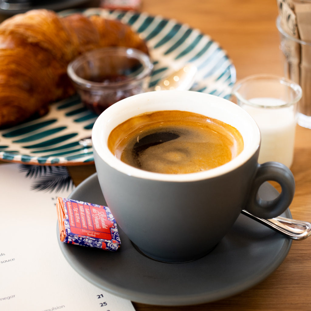 Coffee and croissant at Merci Marcel Orchard