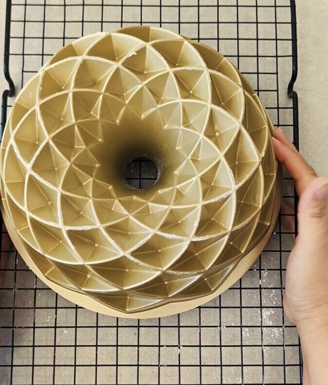 Gluten free coconut lime cake turned out of the bundt tin onto a cooling rack